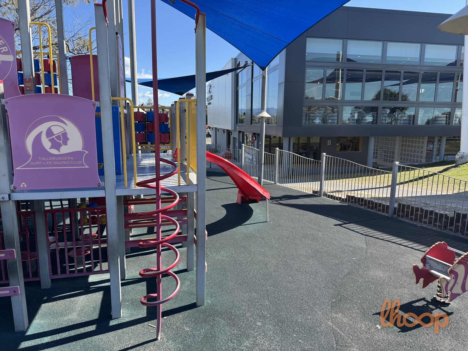 The climbing tower with its Tallebudgera Surf Life Saving Club panel and spiral climber, with the club building behind.